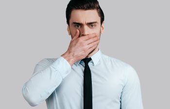 Man Holding Hand Over Mouth Due to Bad Breath Roswell GA