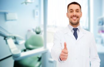 Happy dentist with thumbs up