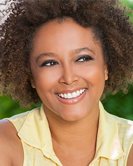 smiling woman with dark curly hair