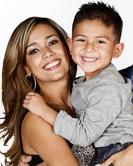 a smiling woman with a smiling boy in her hands