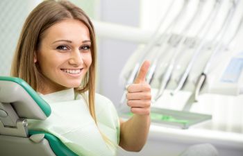 Woman in Dentist Chair Gving a Thumbs Up Roswell, GA