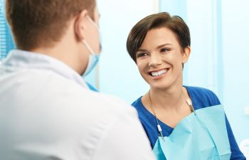 Woman Talking with Dentist while in Dental Chair Roswell, GA