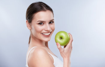 woman holding a green apple